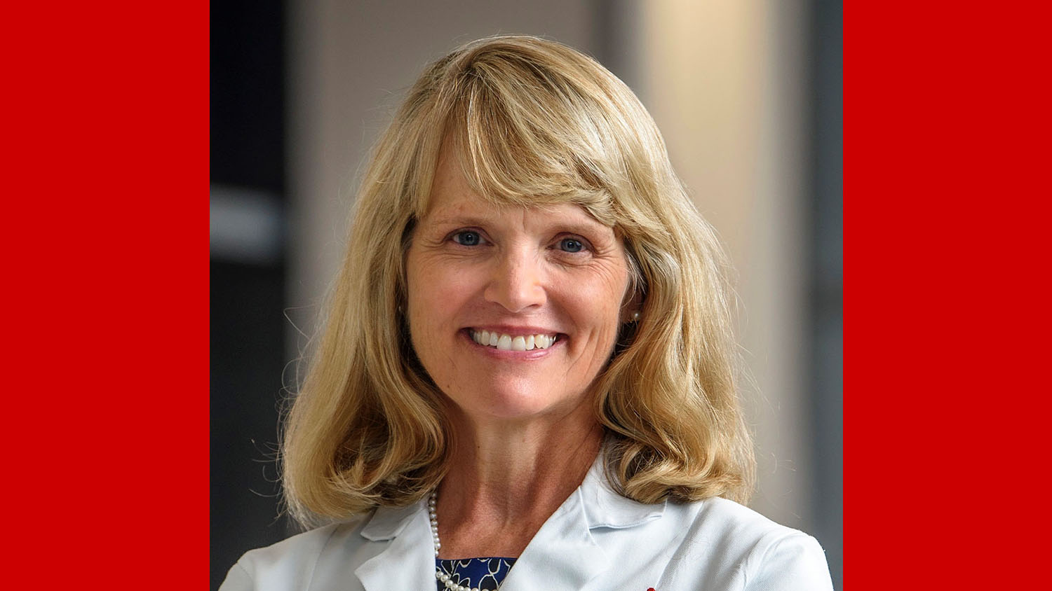 a portrait of a woman wearing a white doctors coat