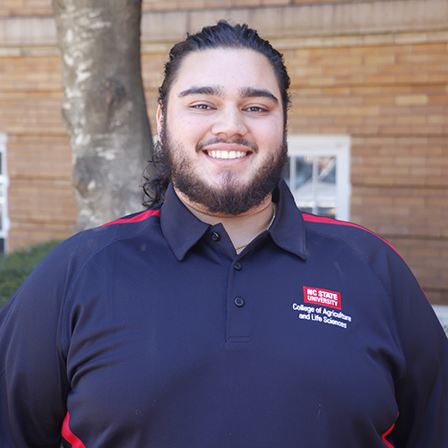 Young man in black shirt smiling