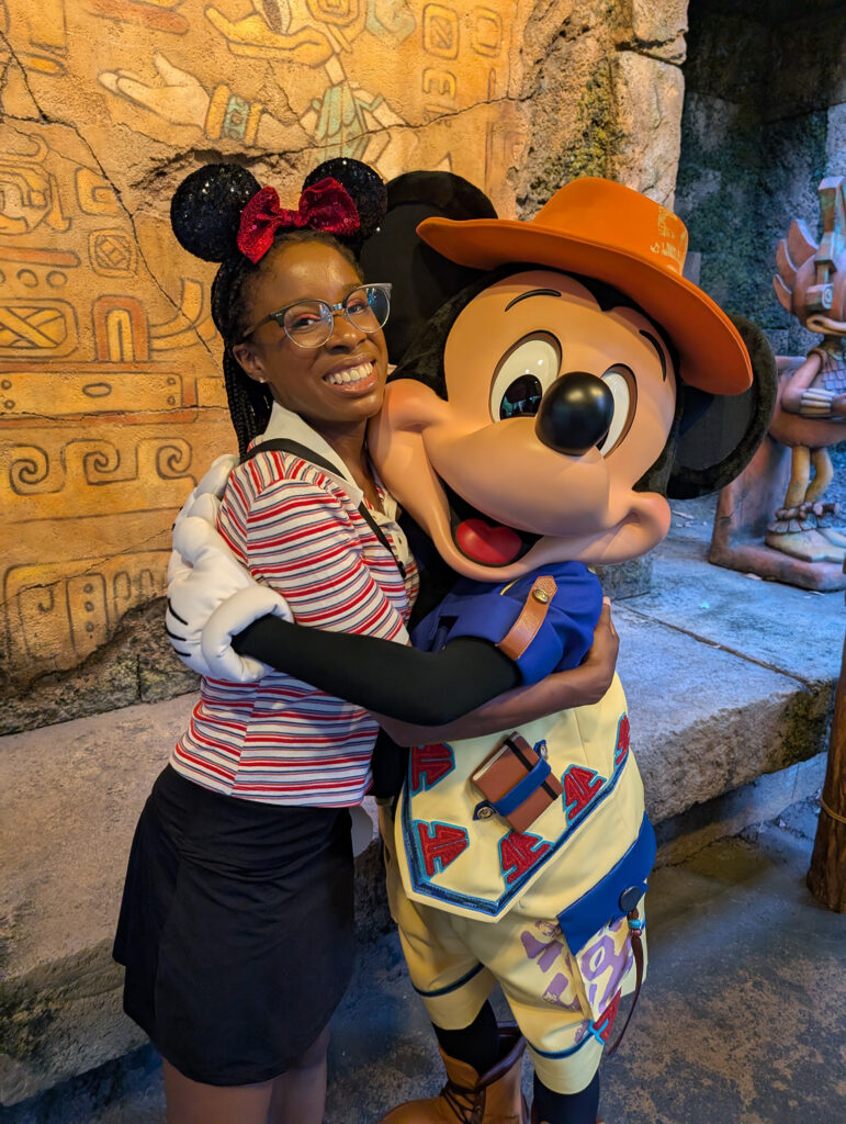 Young woman hugging Mickey Mouse