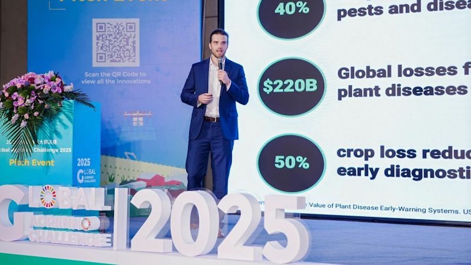 man on a stage presenting a talk about plant protection