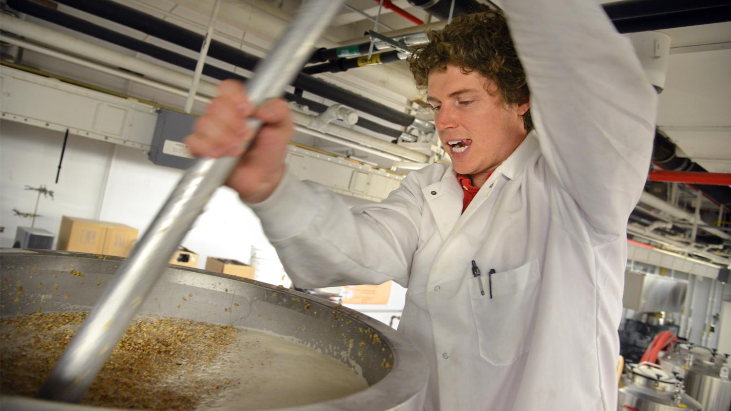 An NC State brewer working in the brewery.