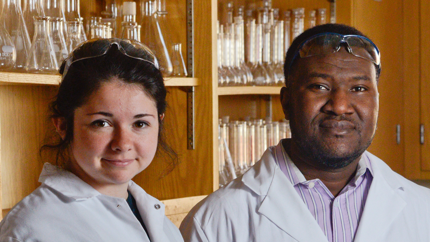 Student and professor pose in lab