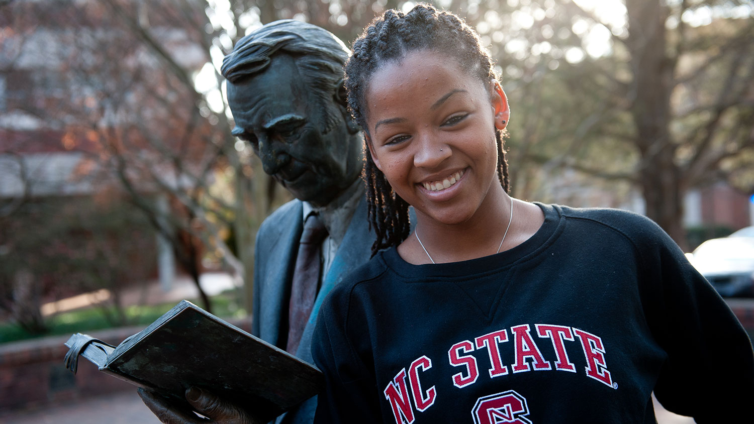 NC State student with Strolling Professor statue