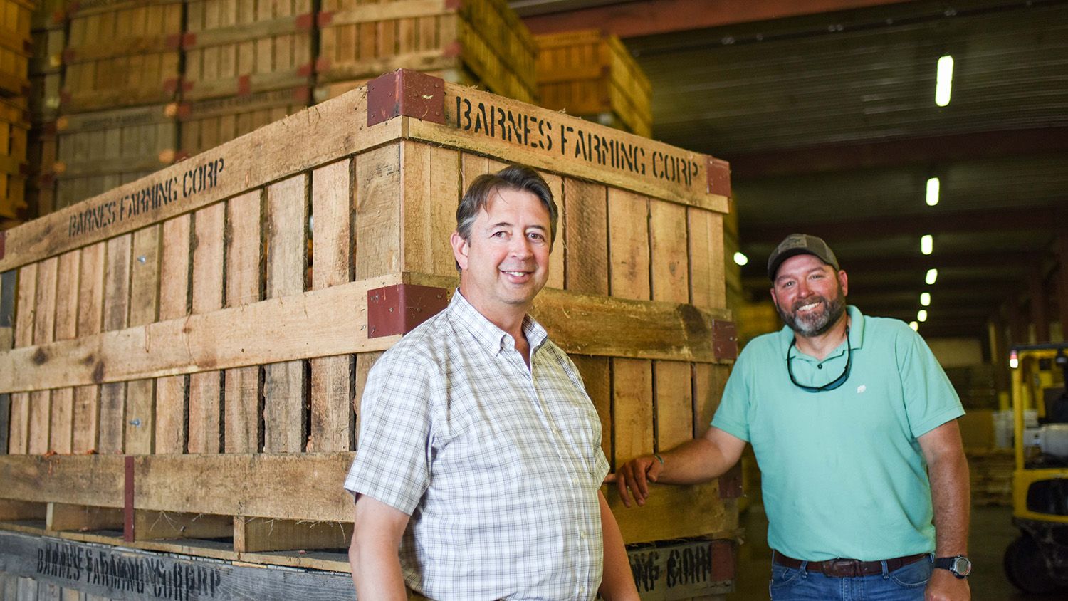 Johnny Barnes and Bryan Salmons in a facility where sweet potatoes are packaged for sale.