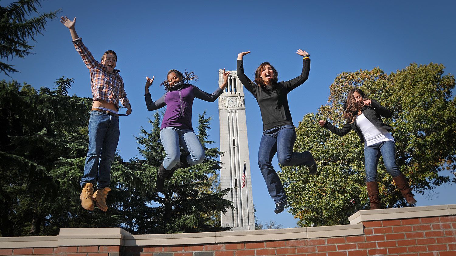 students celebrating by belltower