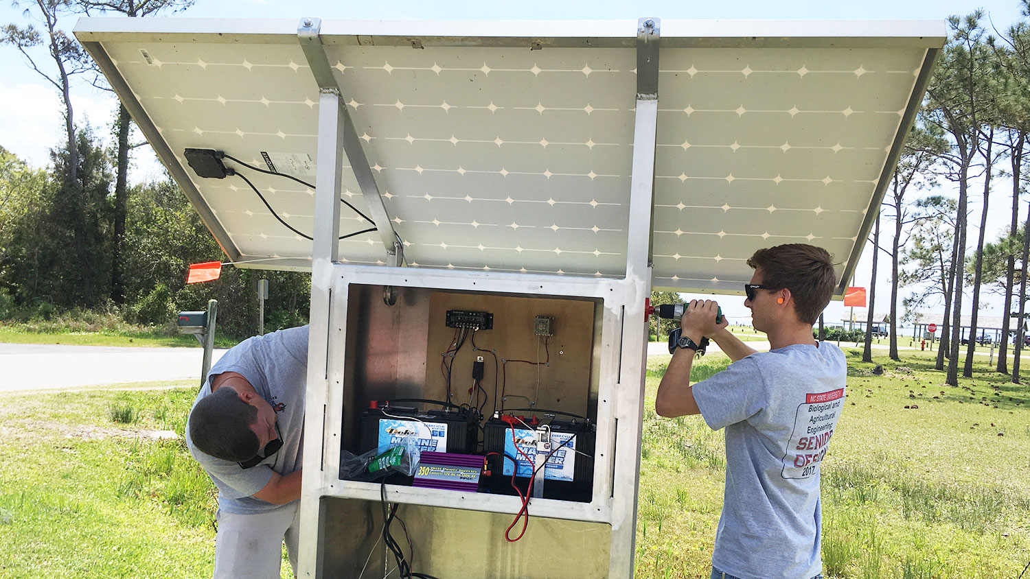 BAE senior design students work on the solar-powered pump they built and installed on Harkers Island