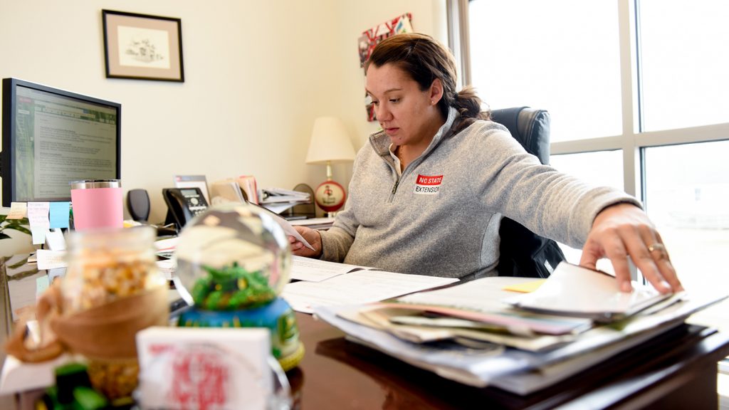 NC State Extension Agent Andrea Gibbs works at her desk.