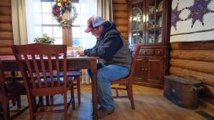 Animal Science major David Cox works on vaccination records at home.