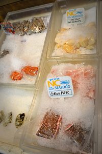 Local seafood laid out in a supermarket for purchase.