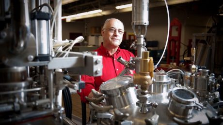 CALS' Josip Simunovic sitting behind laboratory equipment