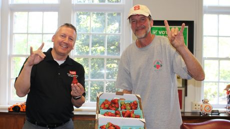 Dean Richard Linton and Rocco Shiavano, posing with wolf hands and strawberries.