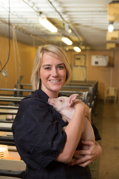 Woman holding a piglet