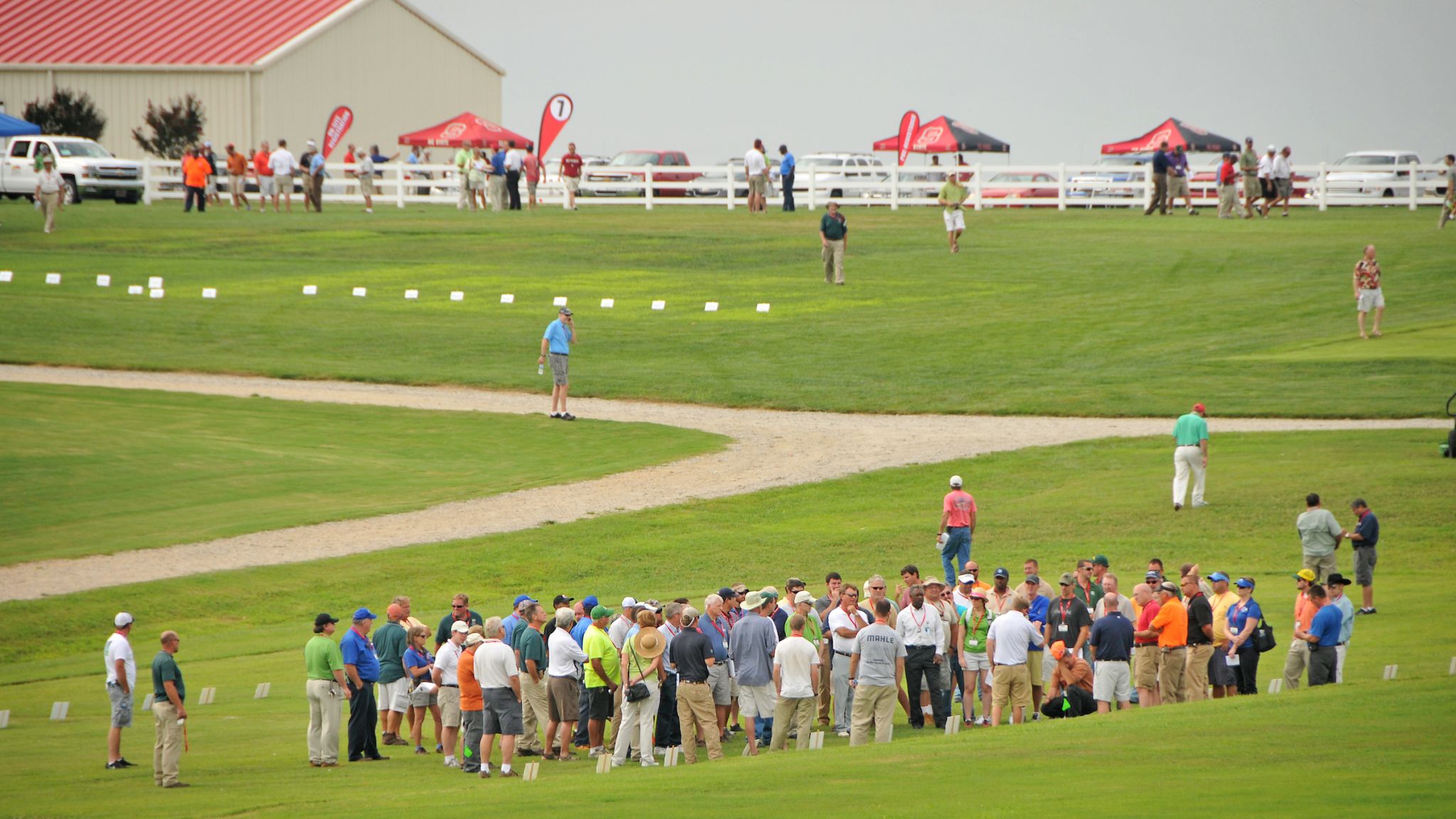 A gathering of people on a turfgrass field.