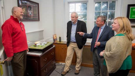 Richard Whitaker (center) inspects a scale model of the Plant Sciences Building after he gave Dean Richard Linton (right) a $7000 check from North Carolina Greenhouse Vegetable Growers’ Association for the building. Launch Director Steve Briggs (left) and Senior Director of Development Dinah Schuster (far right) observe.