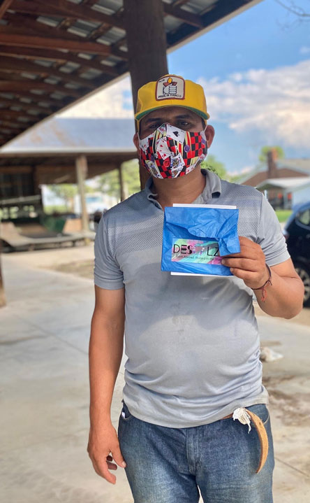 Ever Jimenez Muñoz wears a fabric mask from Descalza at Nichols and Nichols Farms in Wilson County, distributed through N.C. Cooperative Extension’s Farmworker Health and Safety Education Program.