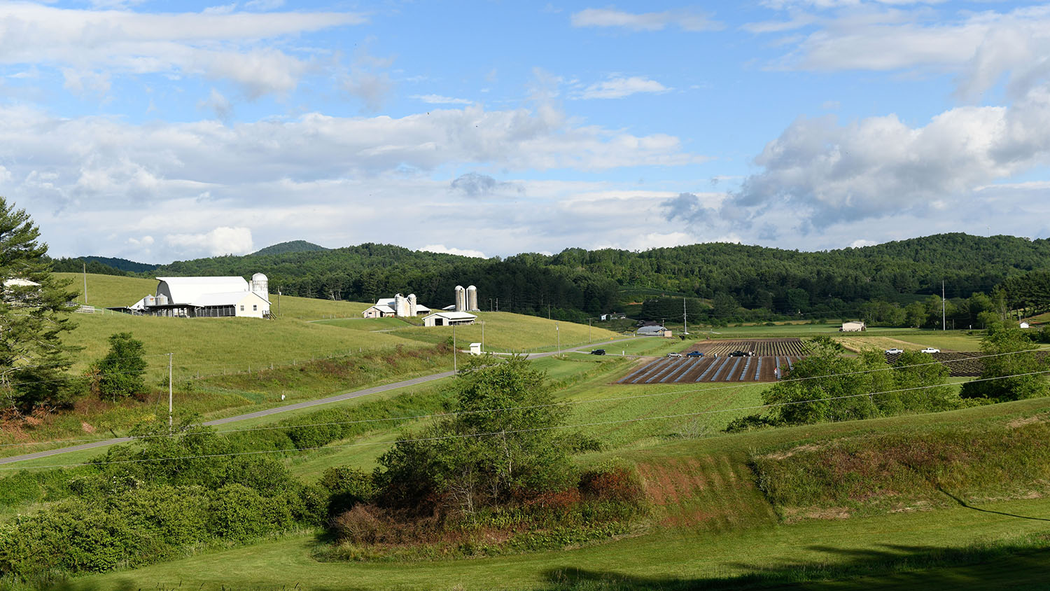 Landscape view of Upper Mountain Research Station with fields and grain silos visable.