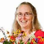 Head and shoulders image of Lucy Bradley with flower bouquet