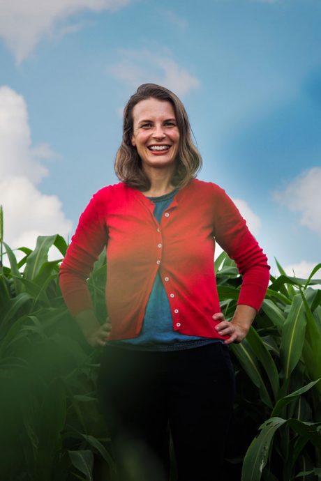 Hannah Burrack in front of a corn field.