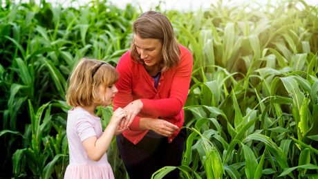 Woman and child in a corn field.